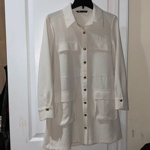 Cream mini dress with pockets, gold buttons, and collar